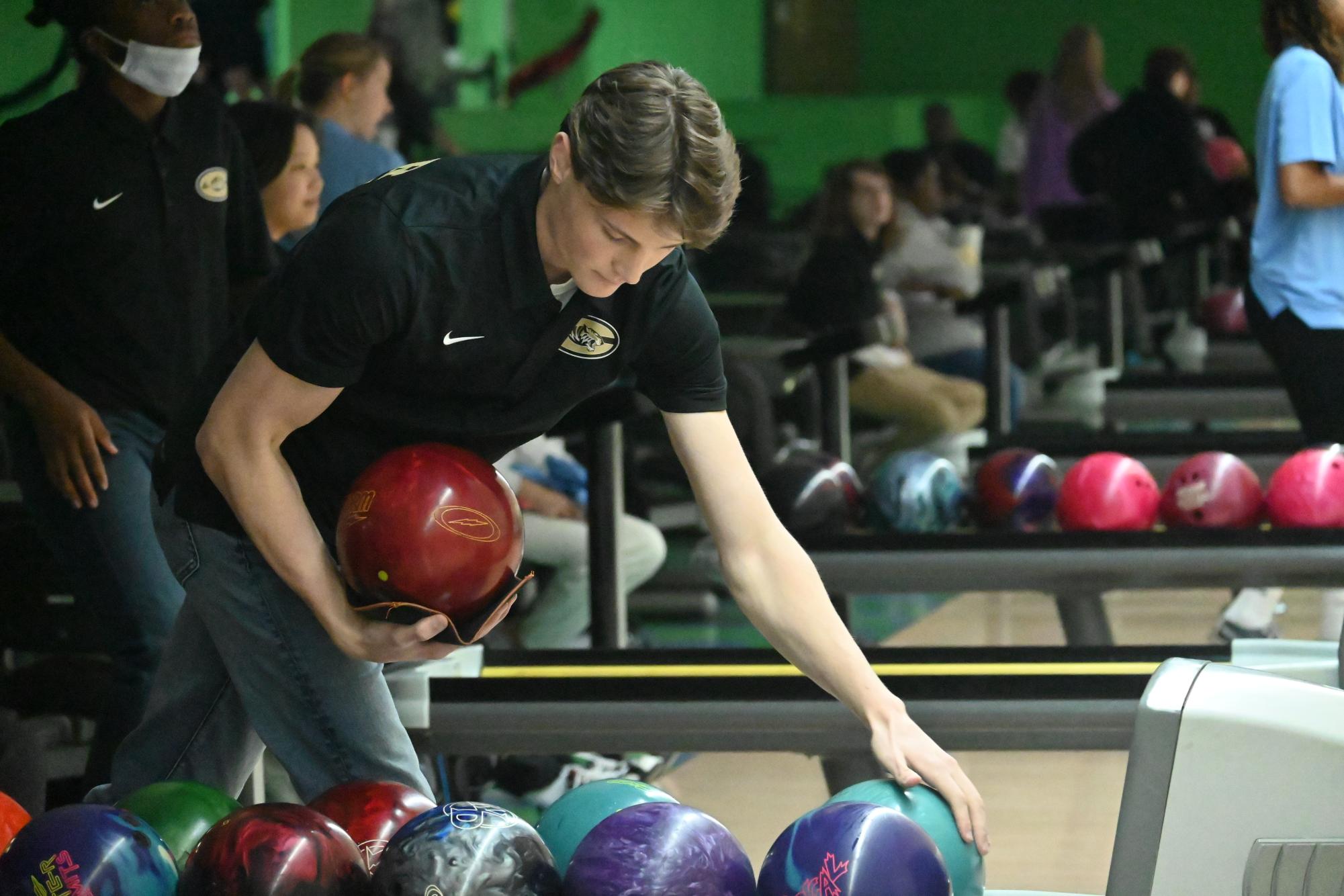 Apology: We misidentified Senior Riley Matthews in The Tiger, Issue 3.  Senior Riley Matthews compares the weights of the bowling balls in preparation for his turn down the lane.