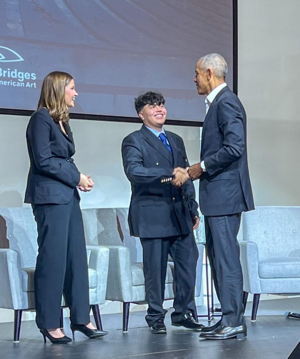 Student Council President Daniel Carrillo greets former President Barack Obama at Crystal Bridges during “Building Bridges: A Conversation with President Obama” Dec. 1, selected as one of three representatives for the Youth Hall. Photo provided by Delmy Carrillo