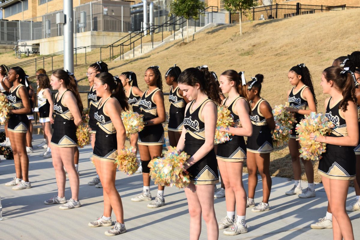 Cheerleaders prepare to give their first cheer at Buddy Coleman Field after celebrating the opening ceremony.