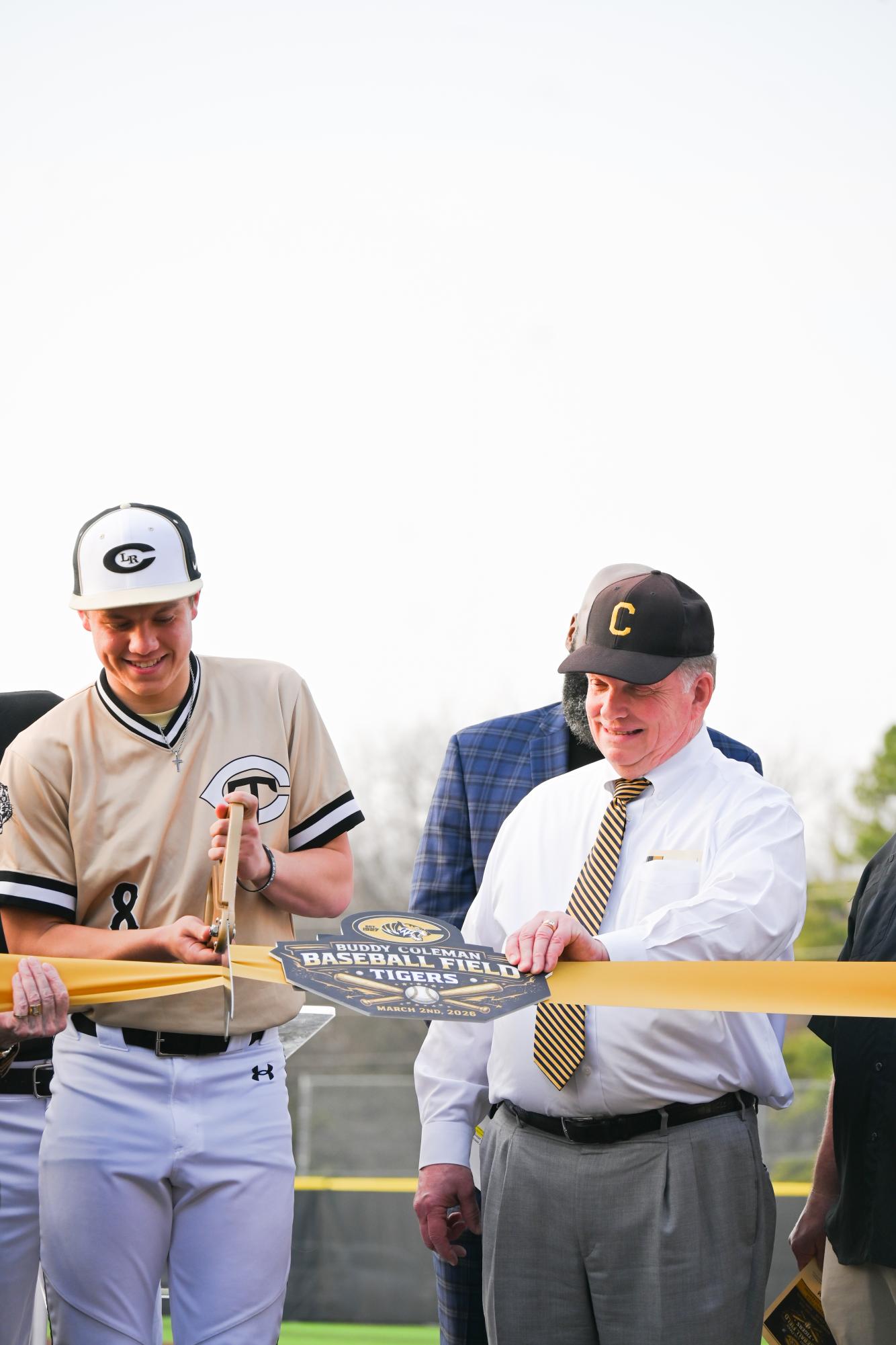 Senior Fisher Declerk and Charlie Coleman, son of Buddy Coleman, cut the ribbon during the opening ceremony. The field is named in honor of Buddy Coleman, Charlie's father. Cheers then erupted, and the celebration began.