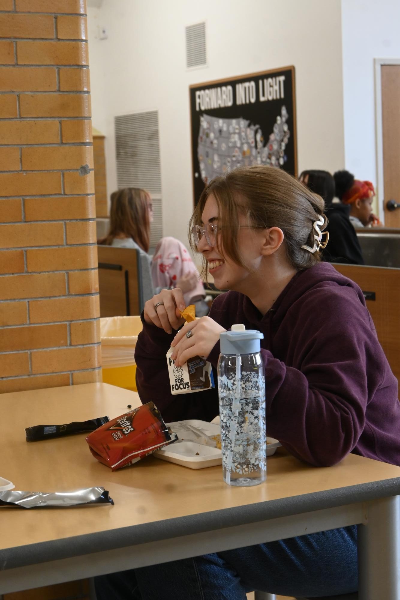 Senior Zora Key sits with her friends while enjoying the taco meal with chocolate milk Jan. 23.