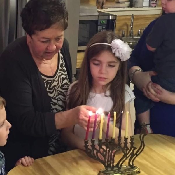 Senior, Hannah Cherepski lights the Hanukkah menorah with her Savta (grandmother) before eating homemade latkes and openning gifts from each other during her family’s annual celebration.