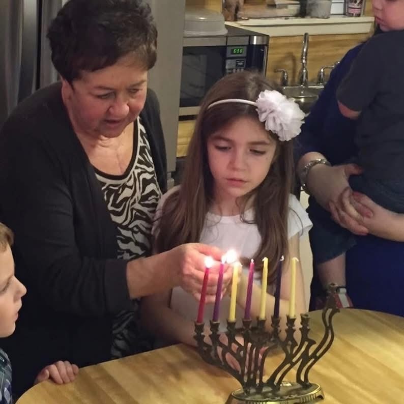Senior, Hannah Cherepski lights the Hanukkah menorah with her Savta (grandmother) before eating homemade latkes and openning gifts from each other during her family’s annual celebration.
