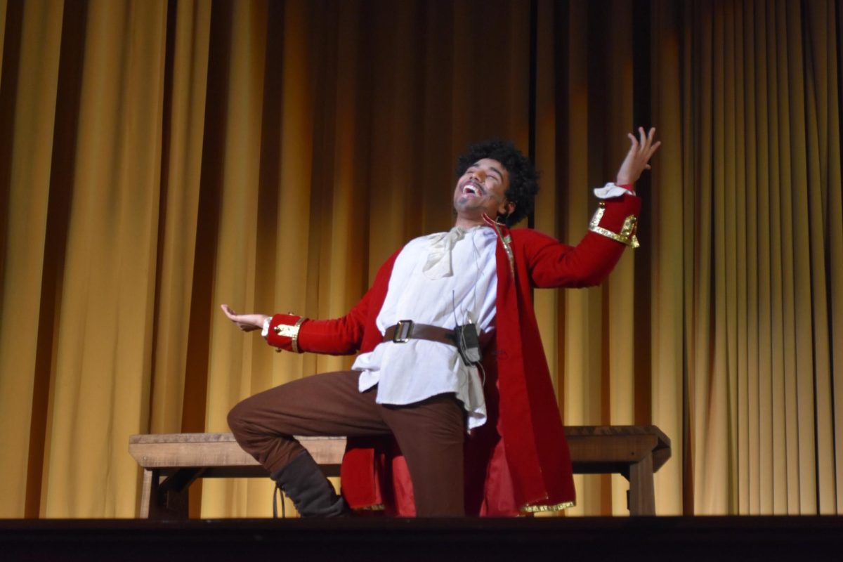 Junior Keegan Washington belts out a solo during his performance as Gaston in the 2023 fall musical, “Beauty and the Beast.”