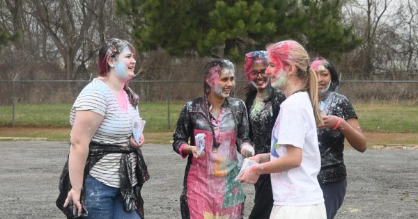 Juniors Rose Matheny, Prisha Tiwari, Dharuna Chandramohan, and Helen Ferguson share smiles after throwing powder at one another March 6.