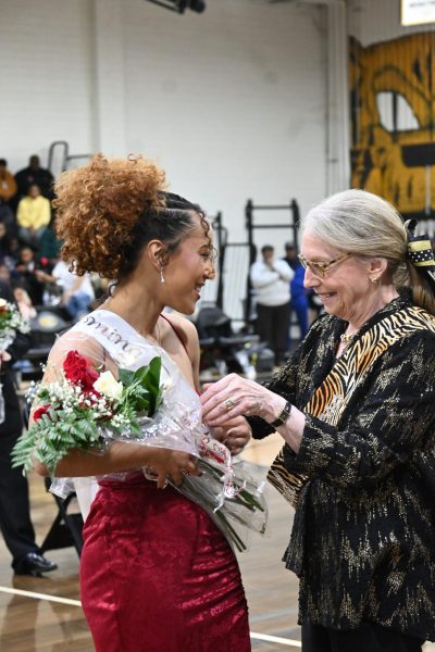 At halftime of the Conway vs. Central basketball game, Principal Rousseau sashes senior Bryah Jackson as Duchess of 2026 Homecoming Court. Jackson is on the Central Girls Wrestling team and the Labyrinth Literary Magazine.