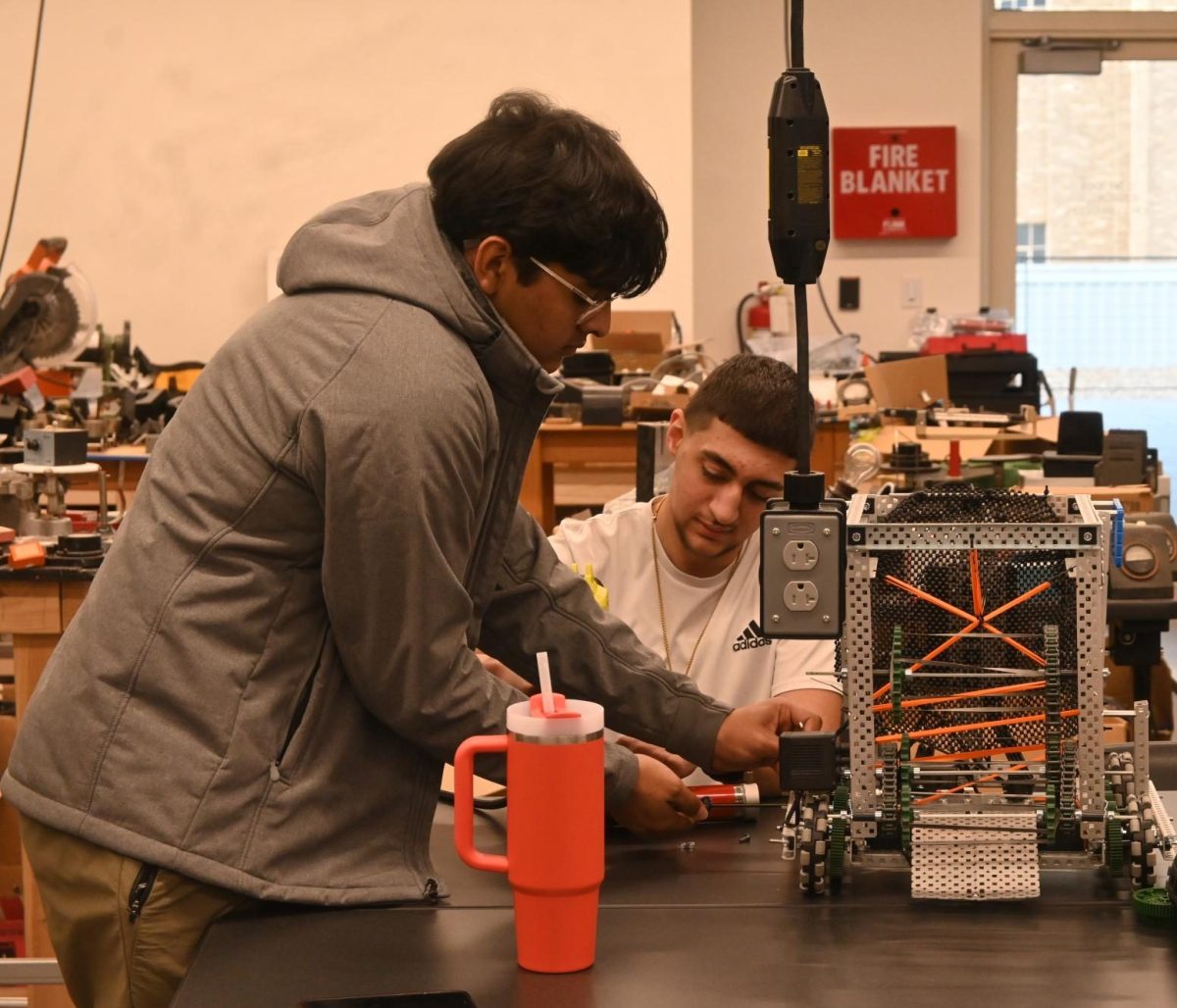 In Patrick Foley's class, SECME members and sophomores Tony Hayar and Zohan Bhimani collaborate to create a VEX robot.