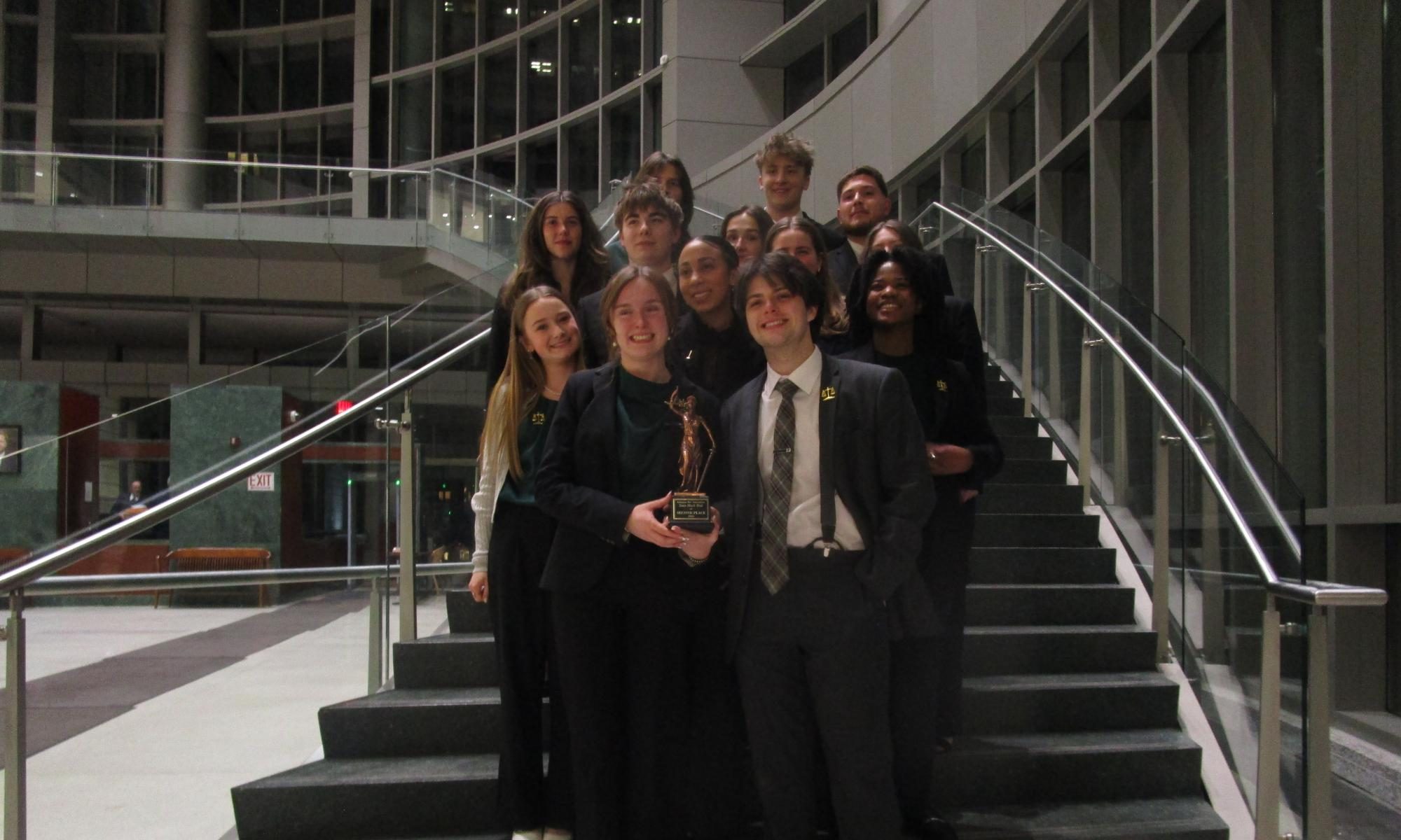 The mock trial A and B teams pose with their trophy after winning second in the state competition. 