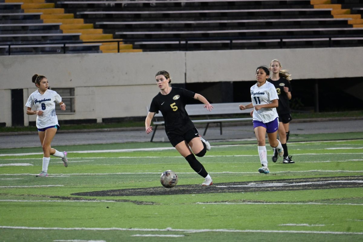 Junior Caroline Kolb dribbles down the fields and looks for a pass. Kolb scored two goals in the 7-0 victory against Little Rock Southwest. 